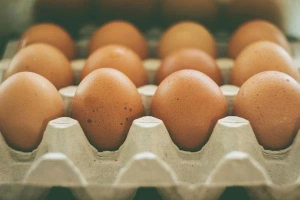 Brown eggs in a cardboard carton.